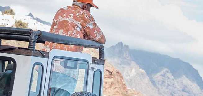 Turysta podziwiający widok na Masca z jeepa