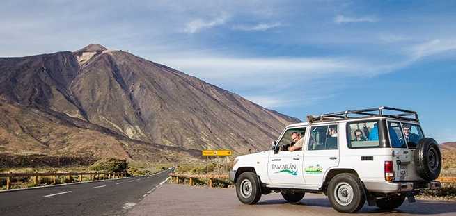 Vehicle and the view of Mount Teide on the private Jeep Safari excursion